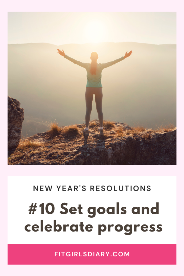 woman celebrating on top of mountain